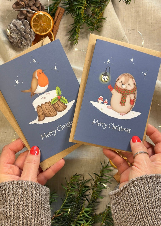 Two Christmas cards held by hands with decorative elements in the background