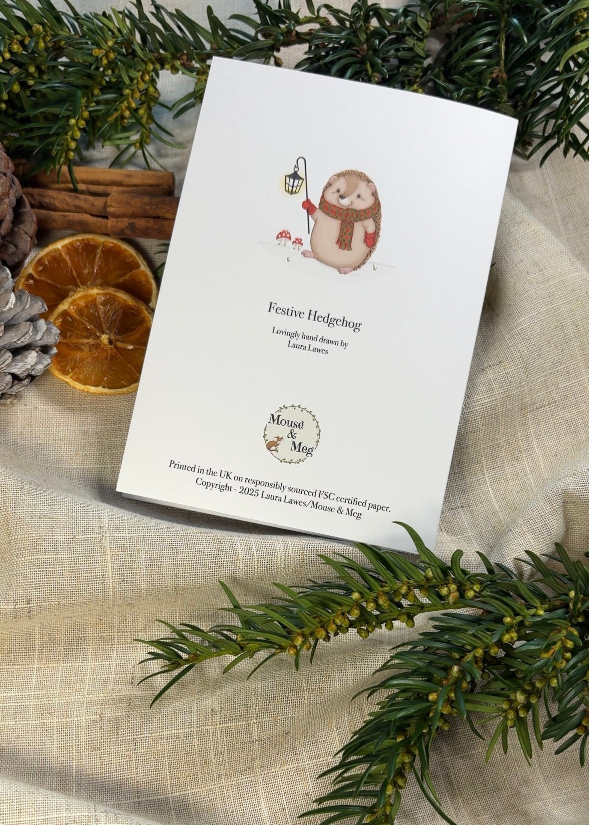 Photograph showing the rear of the Festive Hedgehog Christmas Card in a festive scene.